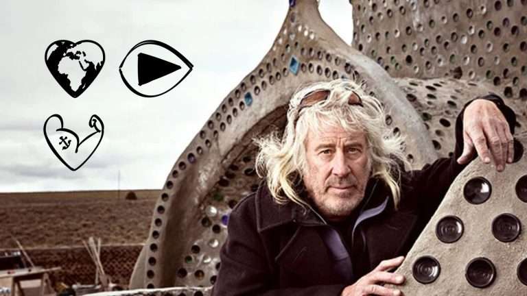 Mike Reynolds in front of an Earthship building